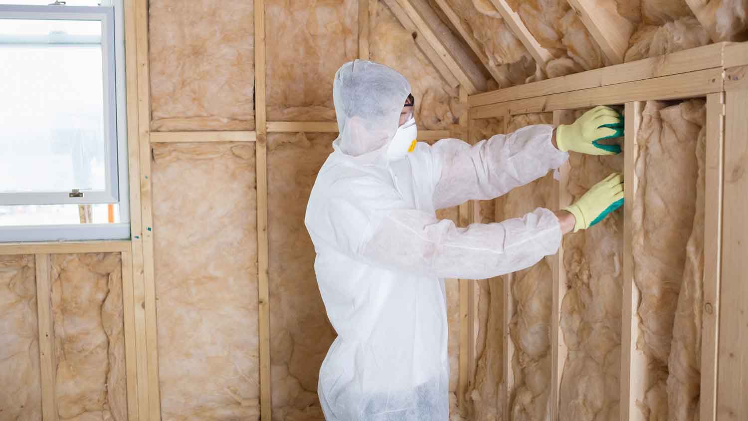 Professional installing insulation in the attic