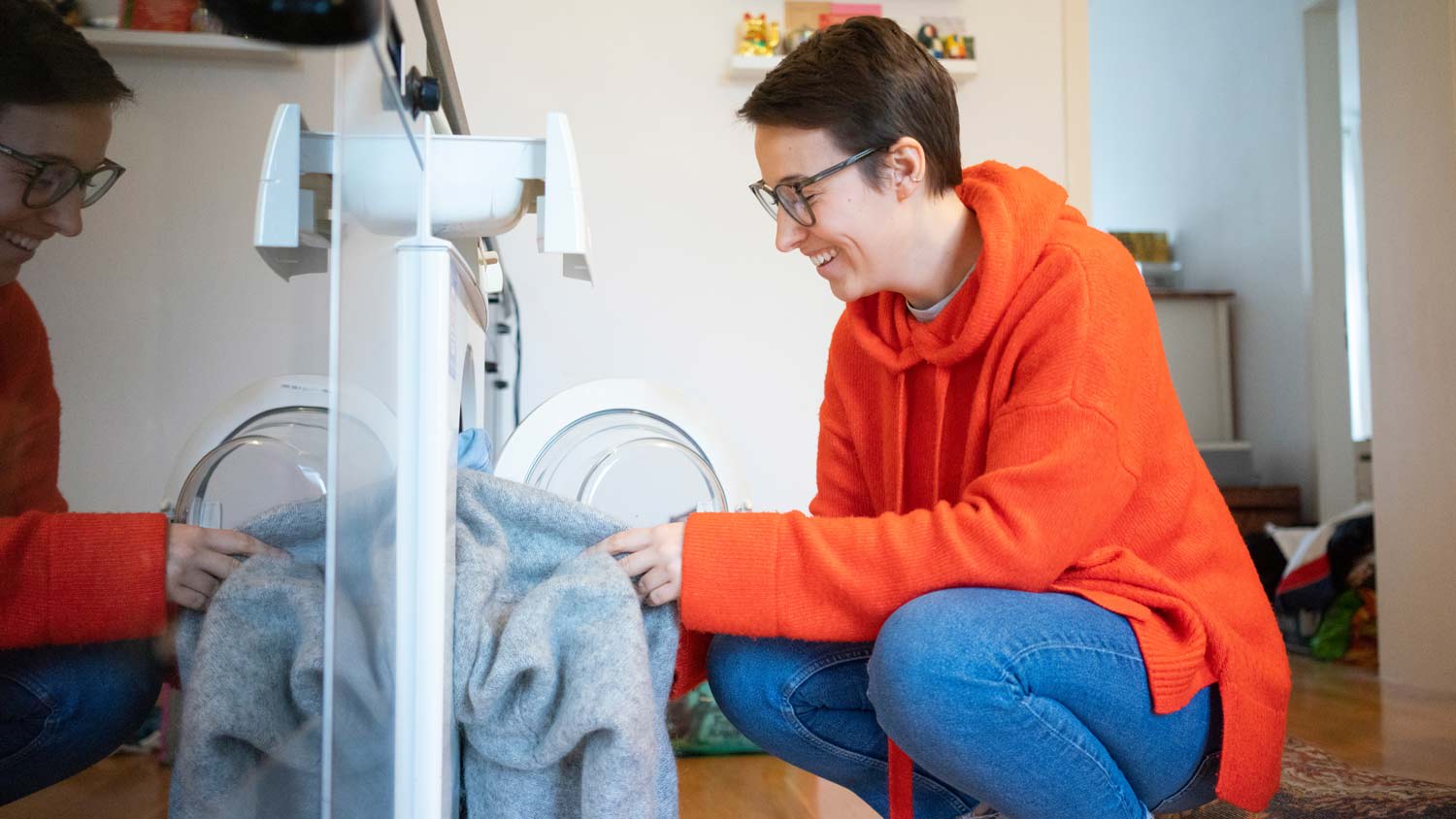 woman putting clothes in the wash