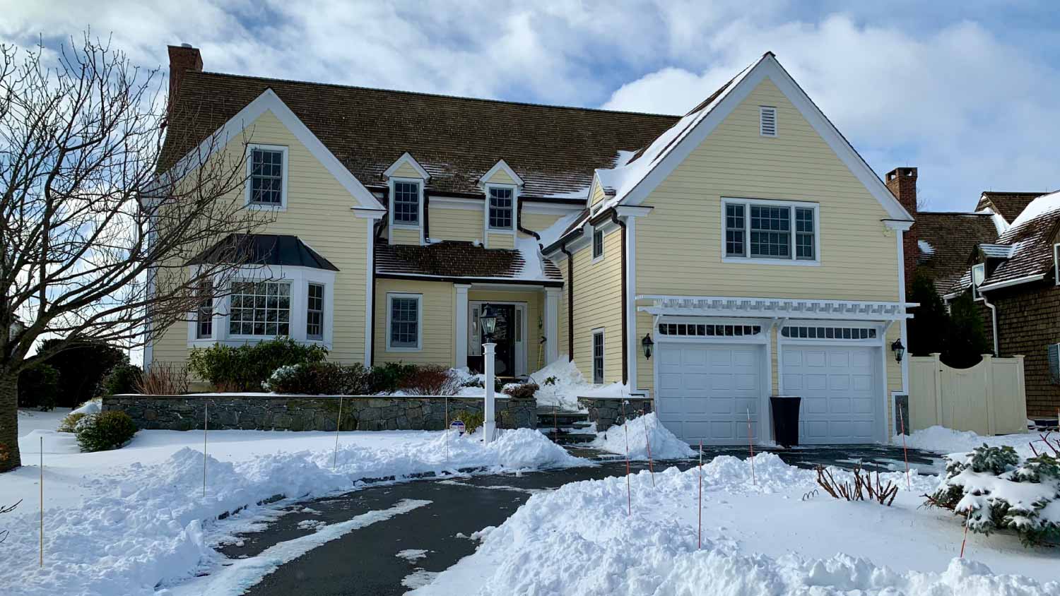 Yellow house is surrounded by fresh snow