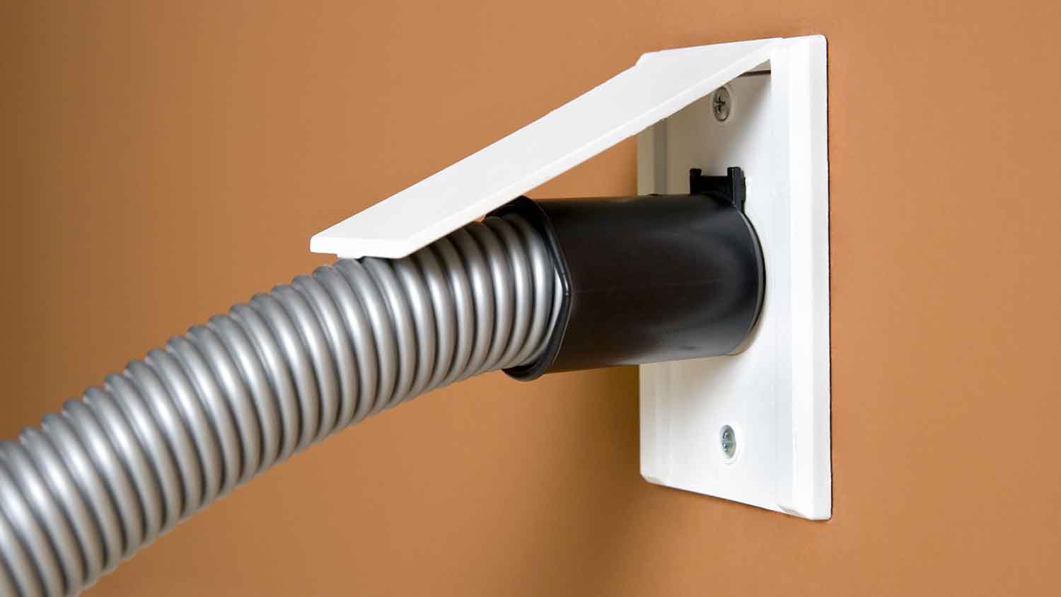 Hose attached to central vacuum system inlet