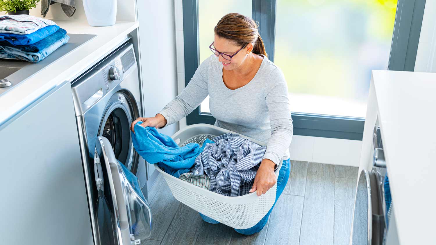 woman putting clothes in the dryer
