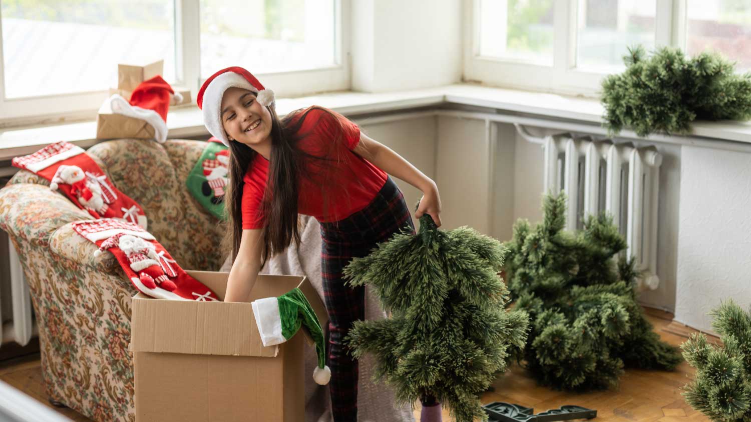 Little girl unpacking Christmas decoration