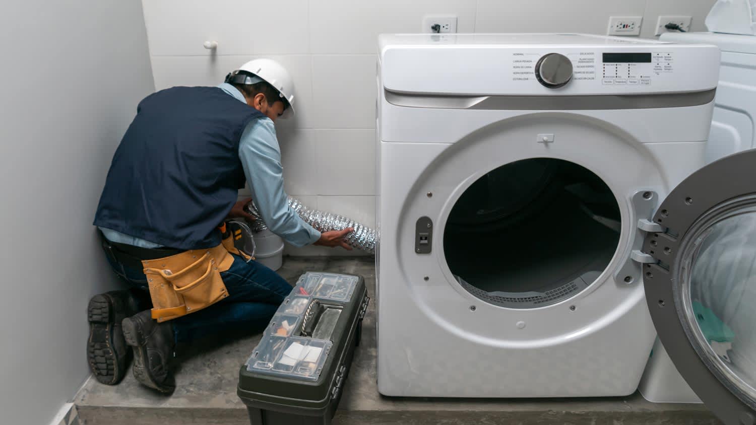 man installing gas dryer