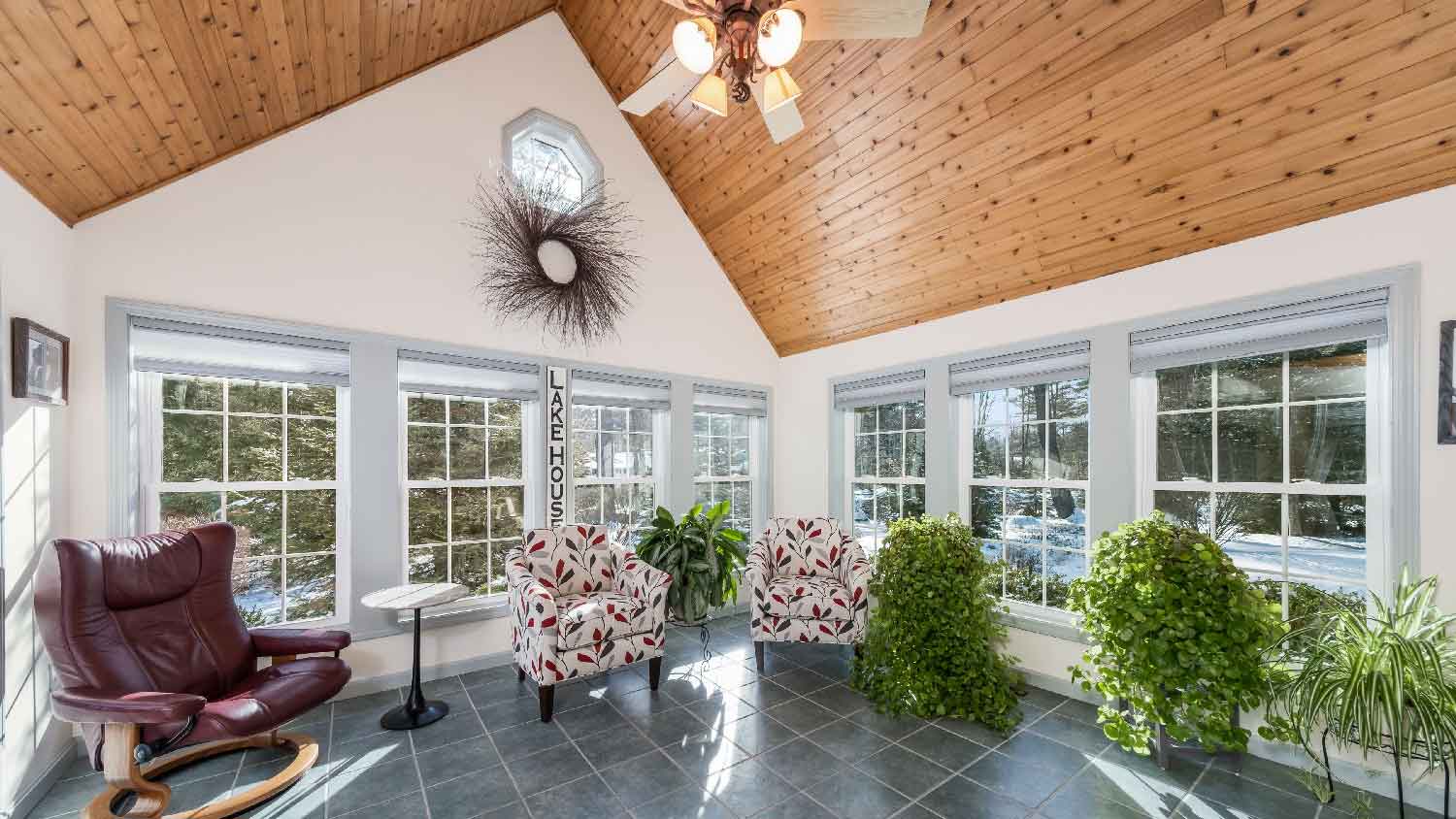 A living room with a wooden cathedral ceiling