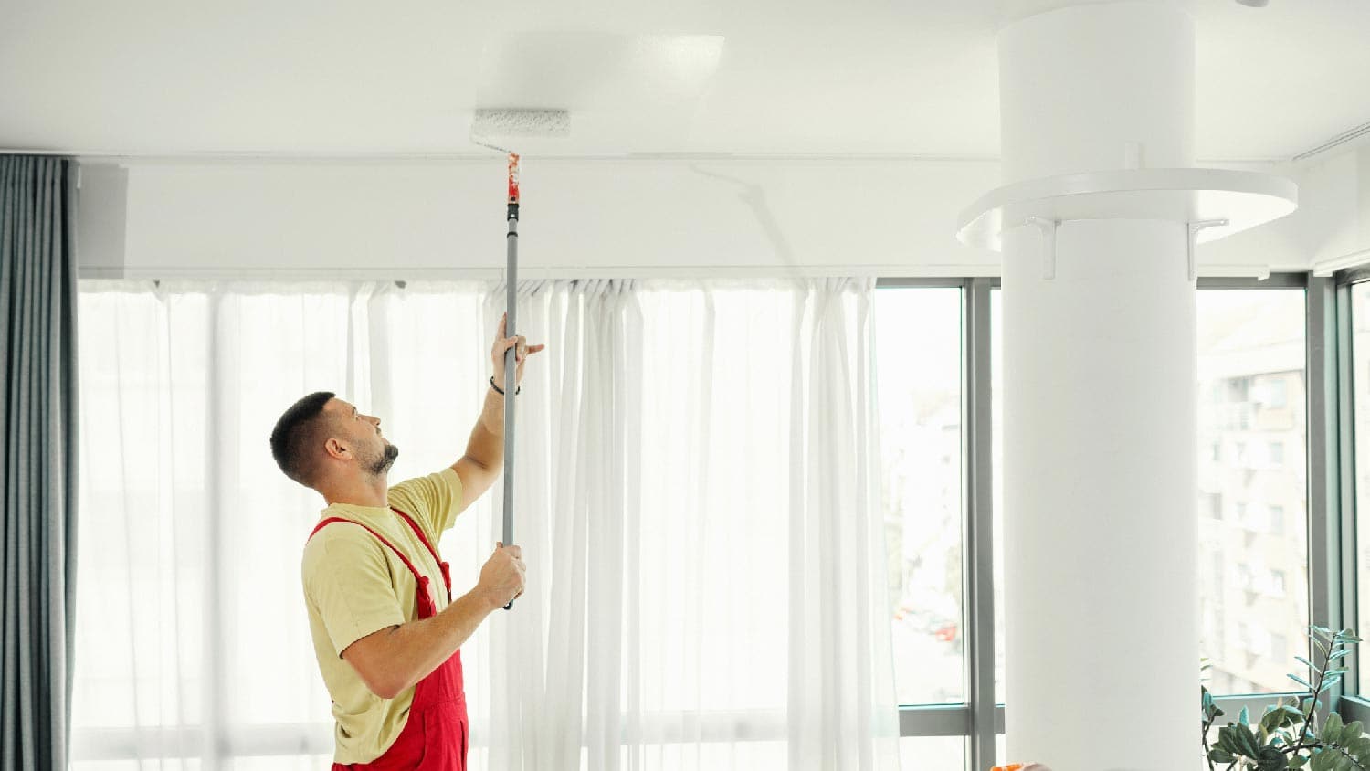A person painting a ceiling
