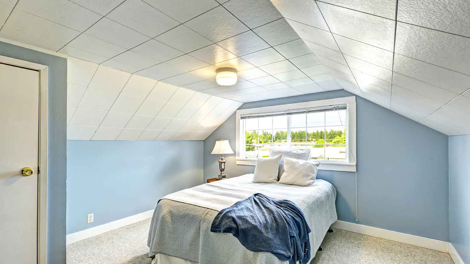 Attic bedroom with ceiling tiles