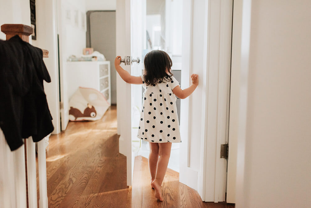 Child opens interior door to another room