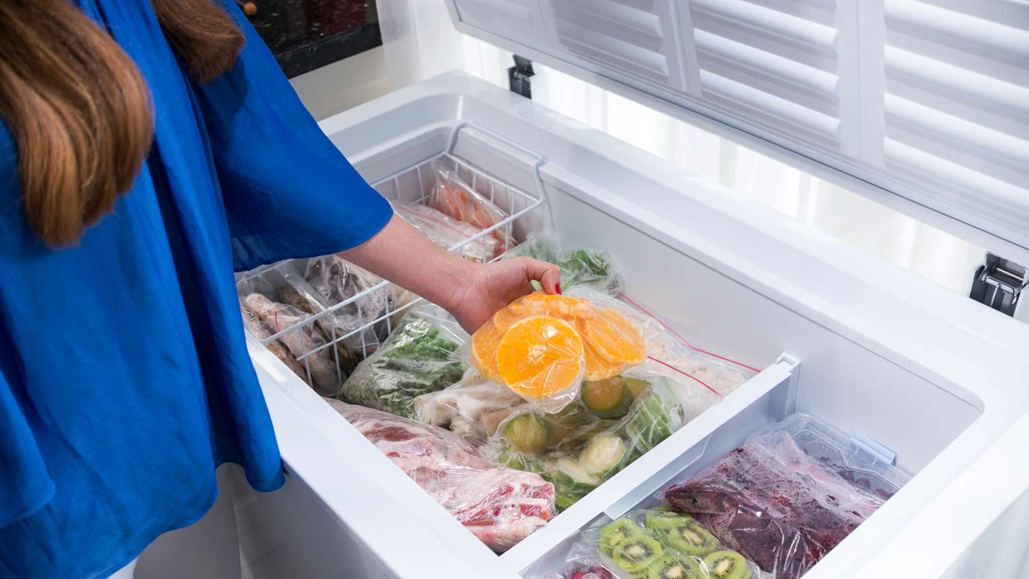 woman putting food into freezer