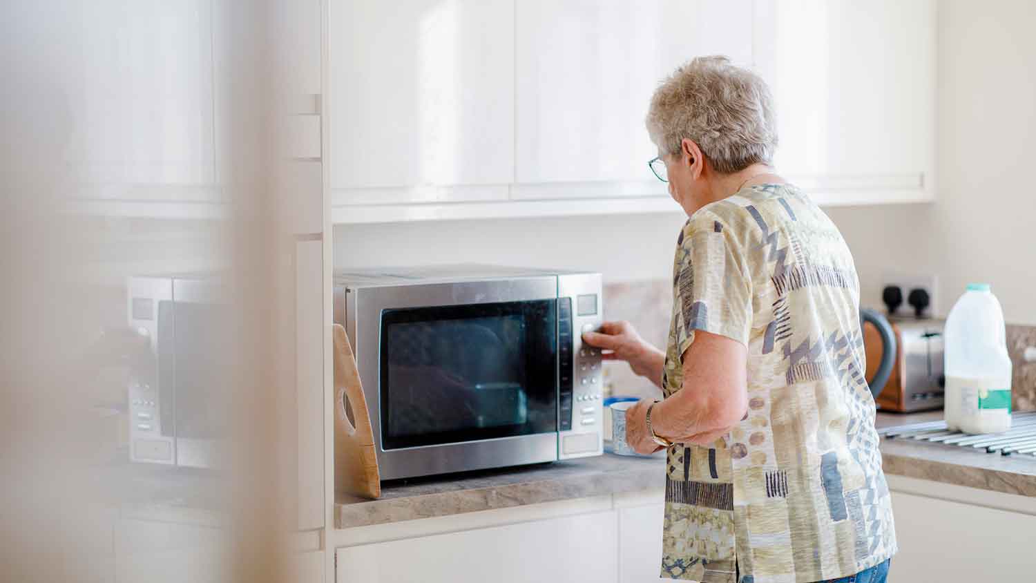 Woman heating dinner in a microwave