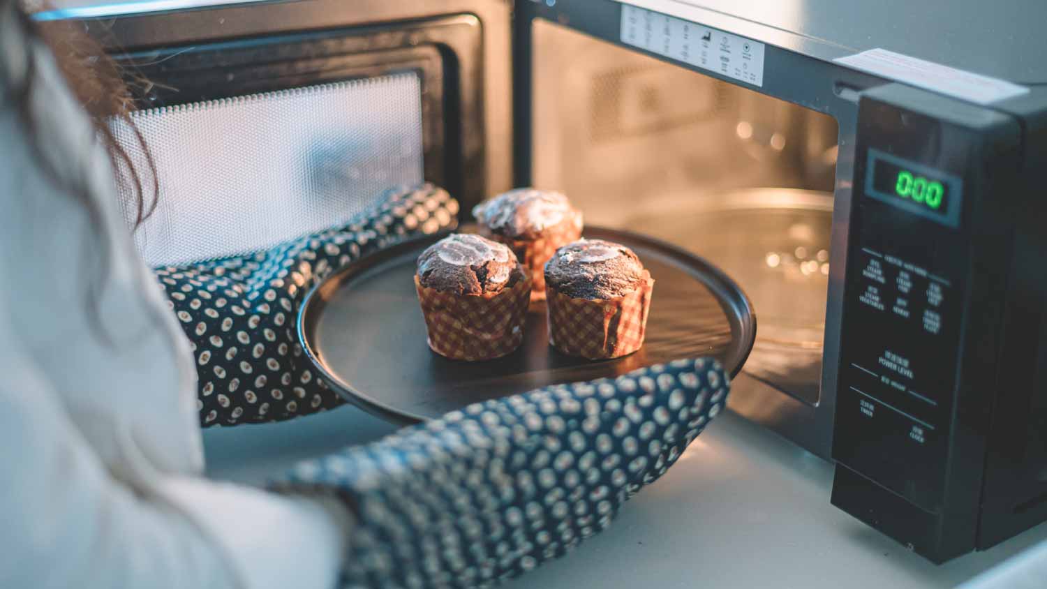Woman putting cakes on a plate to microwave