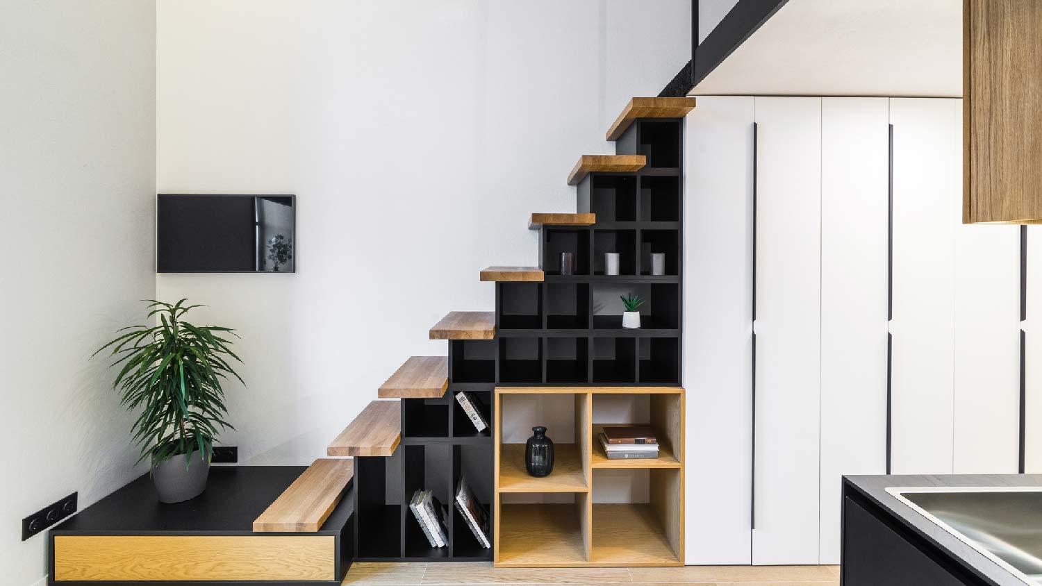 A bookcase under the stairs