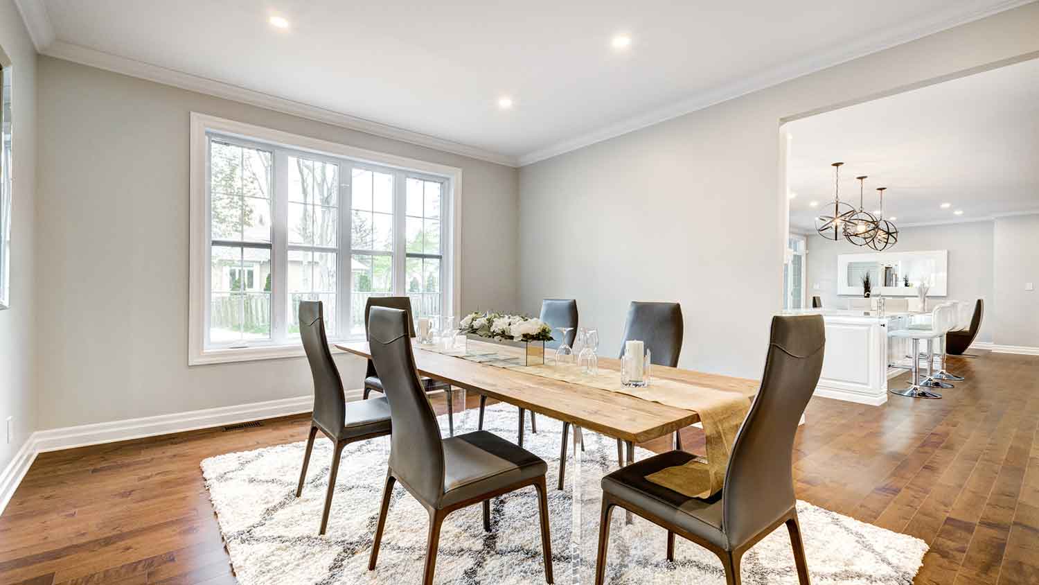 Dining room interior with crown molding and hardwood flooring