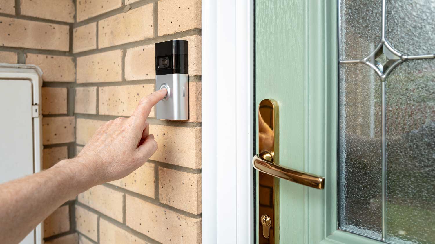 A person ringing a video doorbell