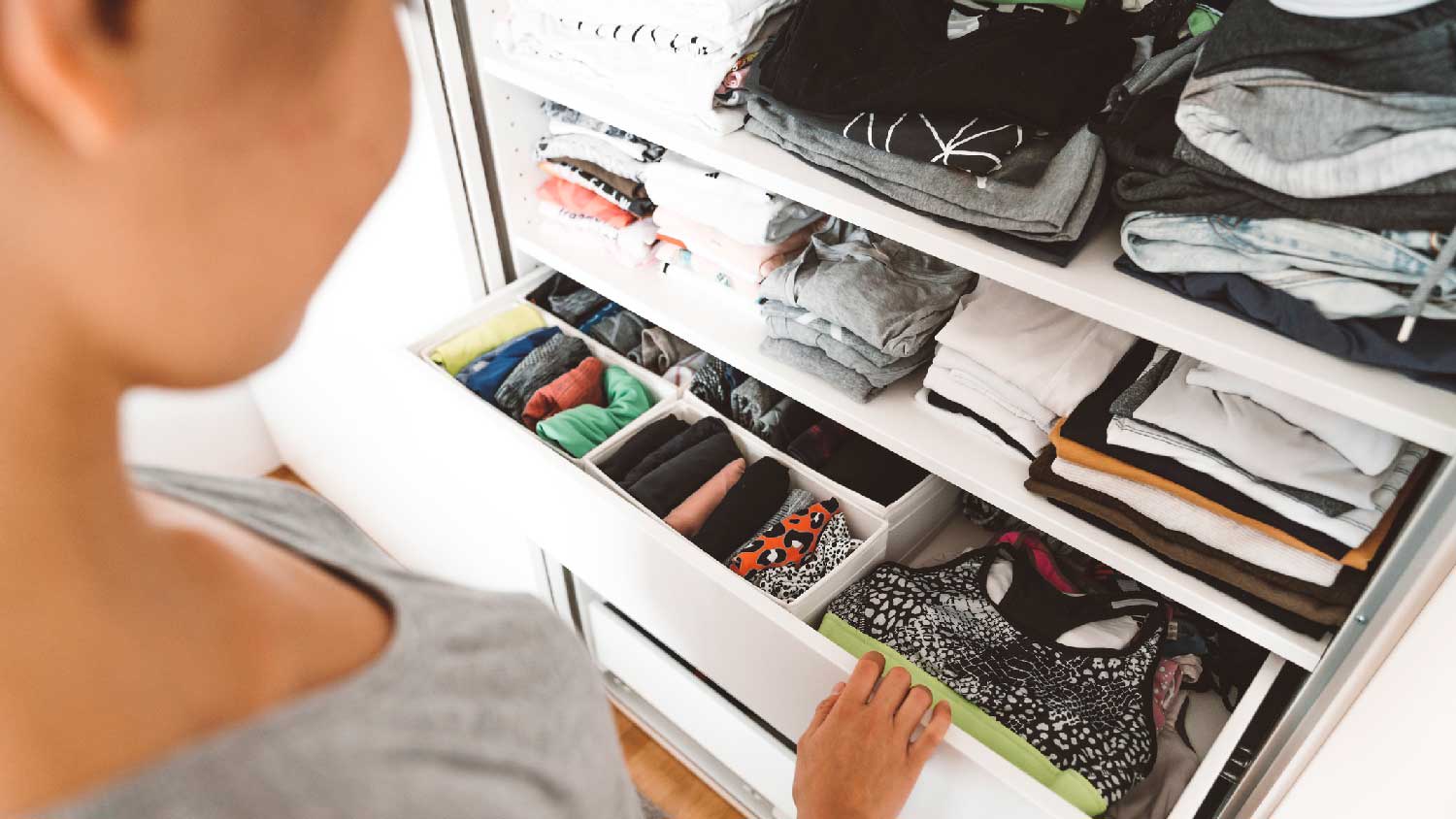 A person looking for clothes in a closet