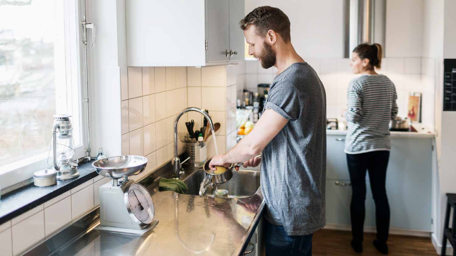 Man washing saucepan