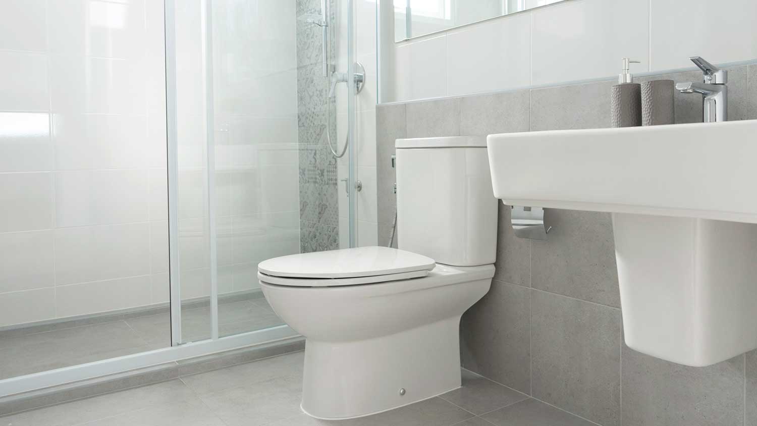 Gray tiles installed on the wall and floor of the bathroom