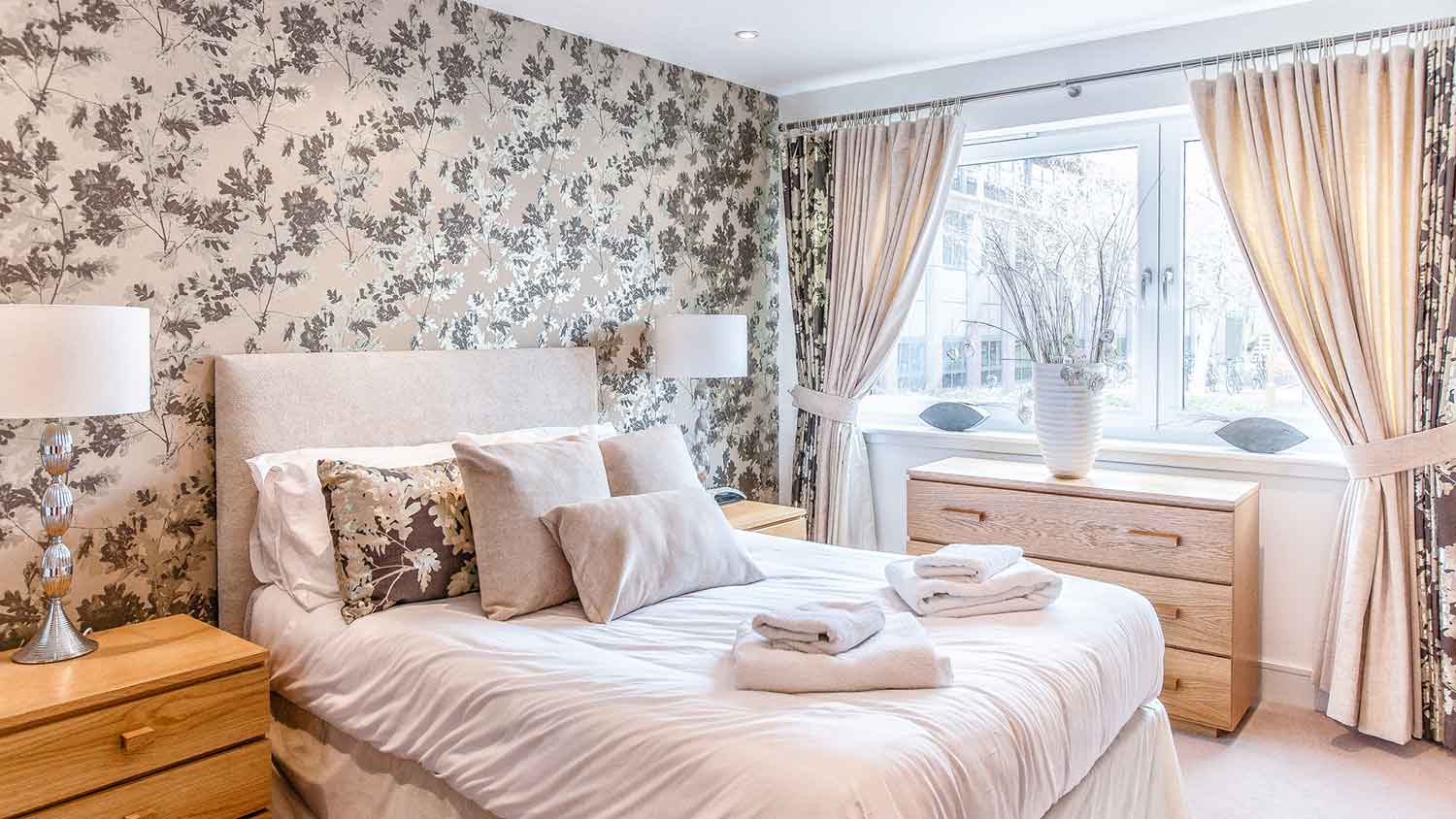 Bedroom accent wall with floral wallpaper