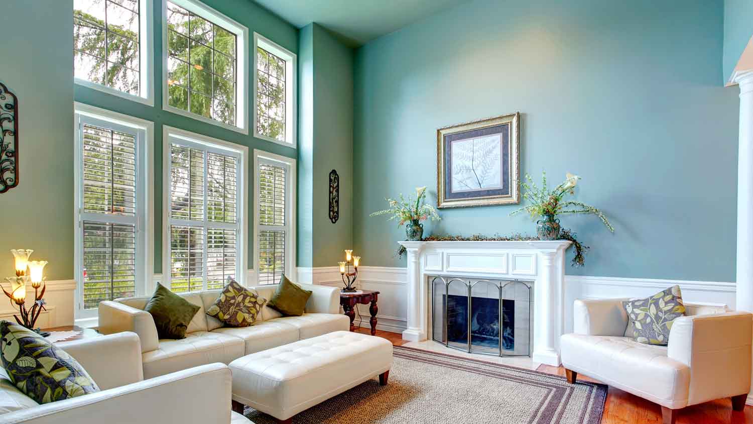 Living room interior with blue walls and tall windows