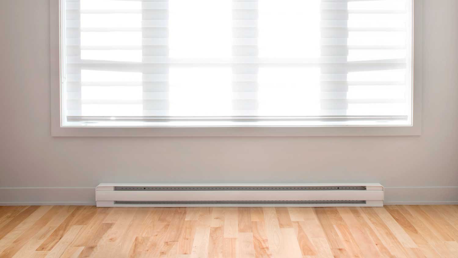 Baseboard installed below a large window in an empty room