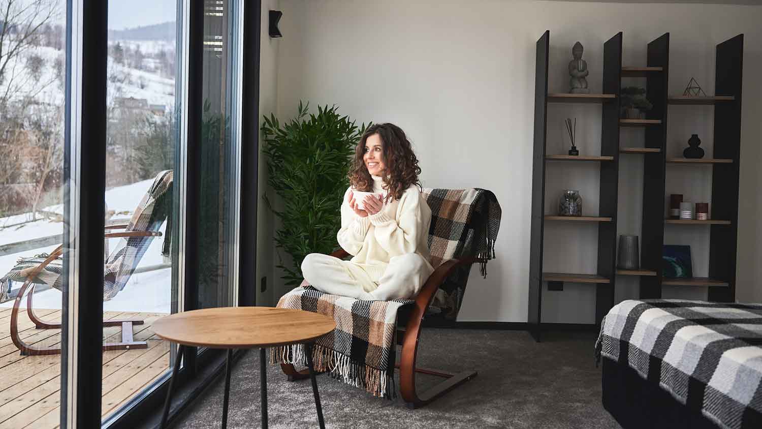 Woman enjoying the winter landscape from the bedroom
