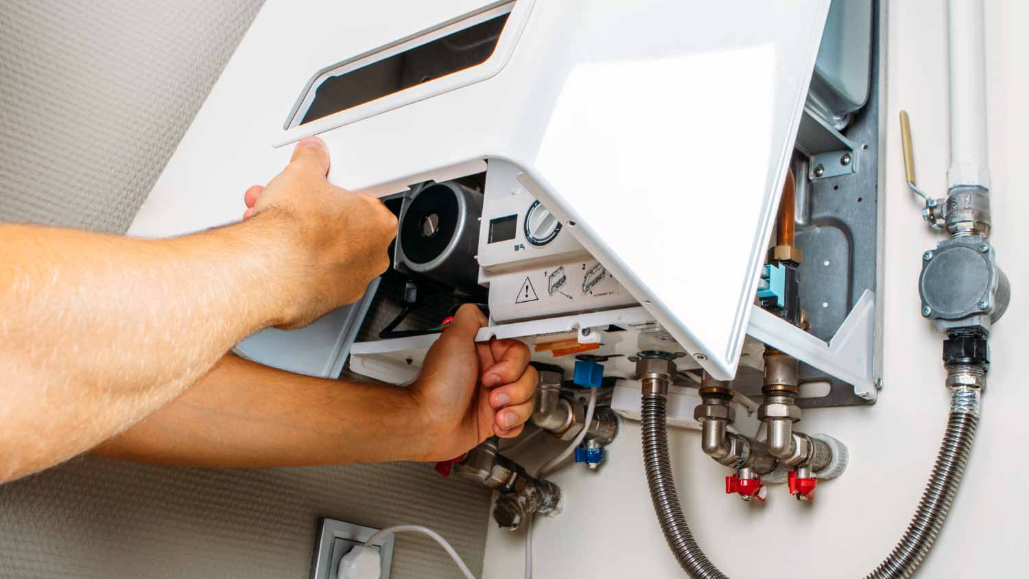 Plumber fixing water heater