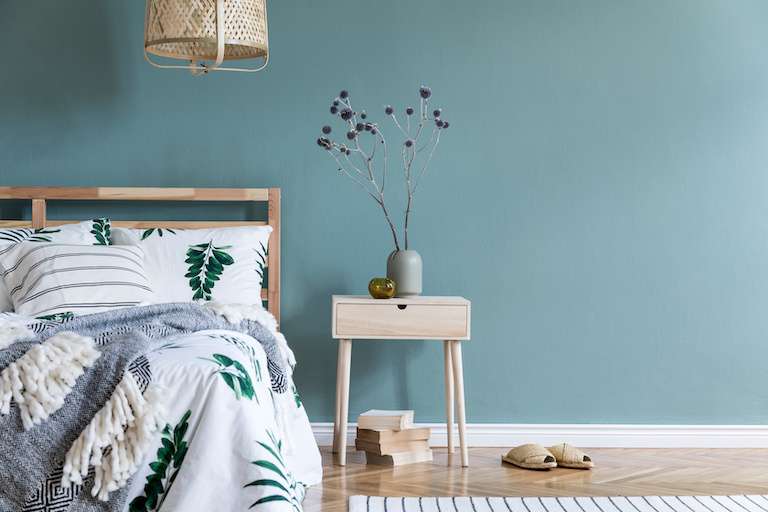 a furnished bedroom with blue walls