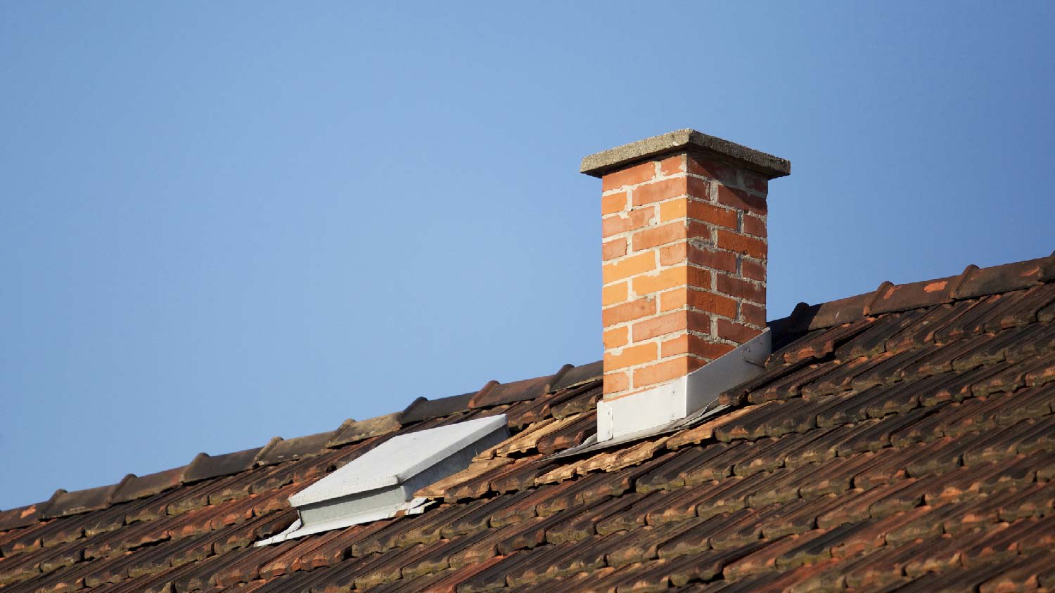 A brick chimney on a roof