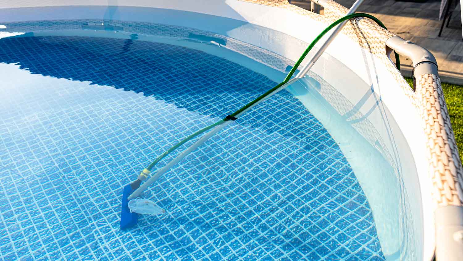 Cleaning an above ground swimming pool with a brush