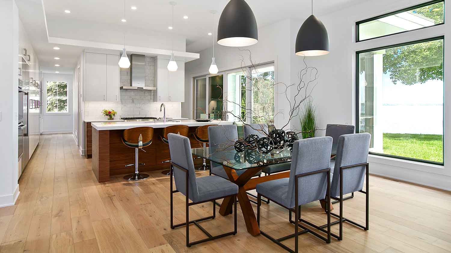 Renovated dining room with pendant lights and hardwood floors