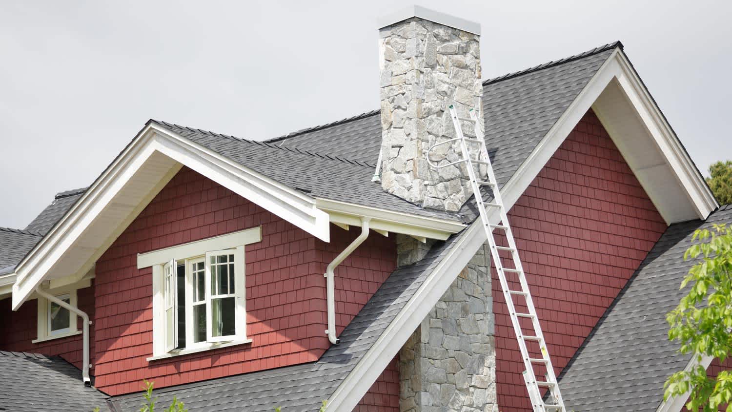 Red house with ladder leading to roof