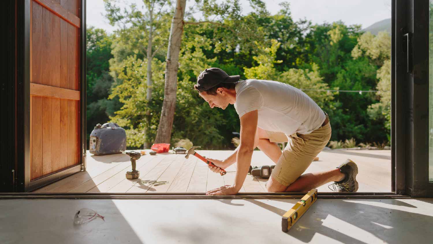 A man building a wooden deck