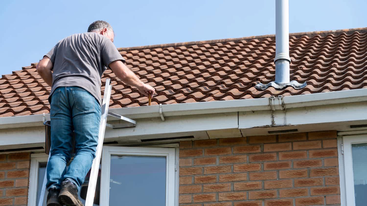 Man examining roof