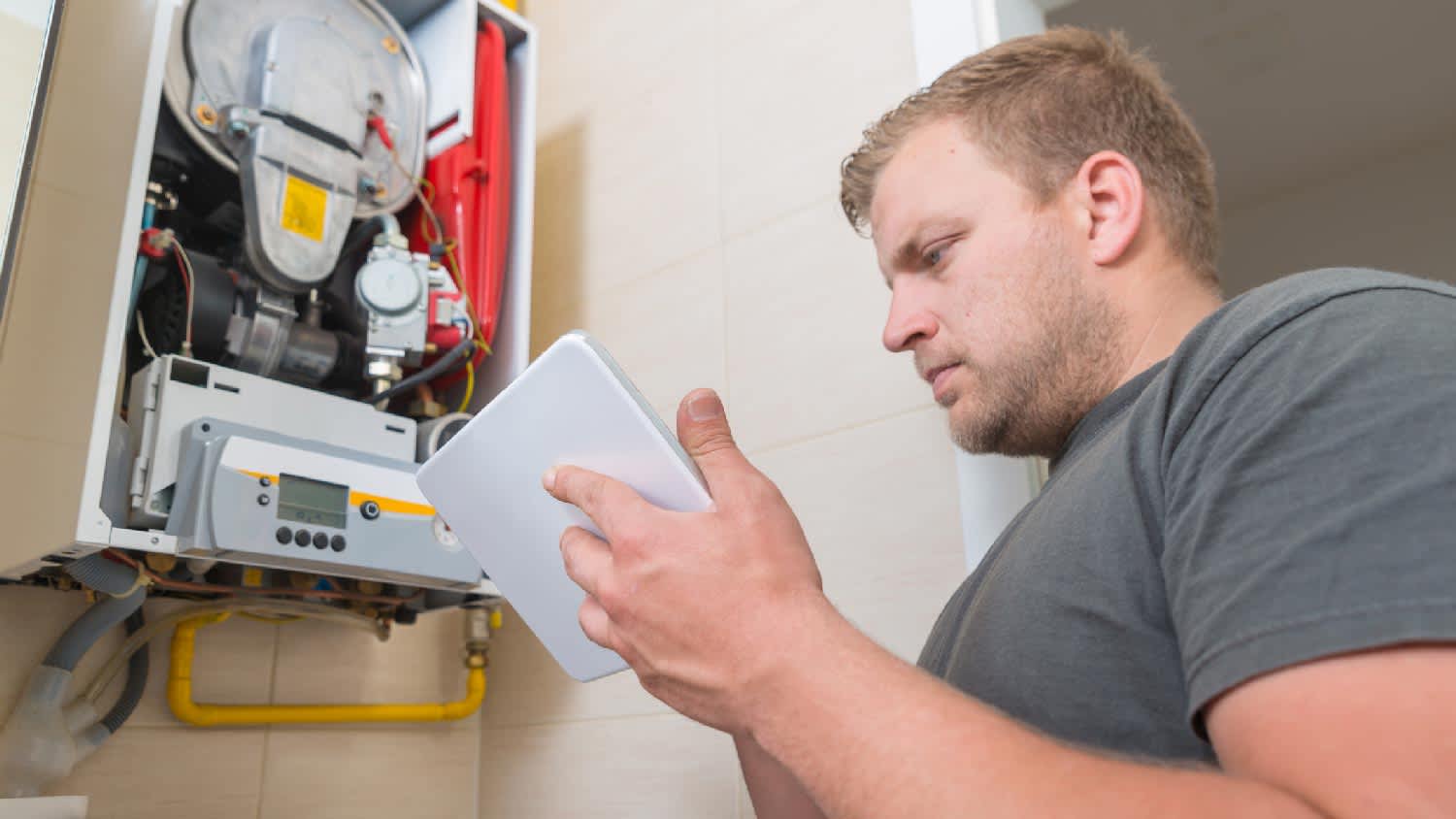 A professional inspecting a furnace