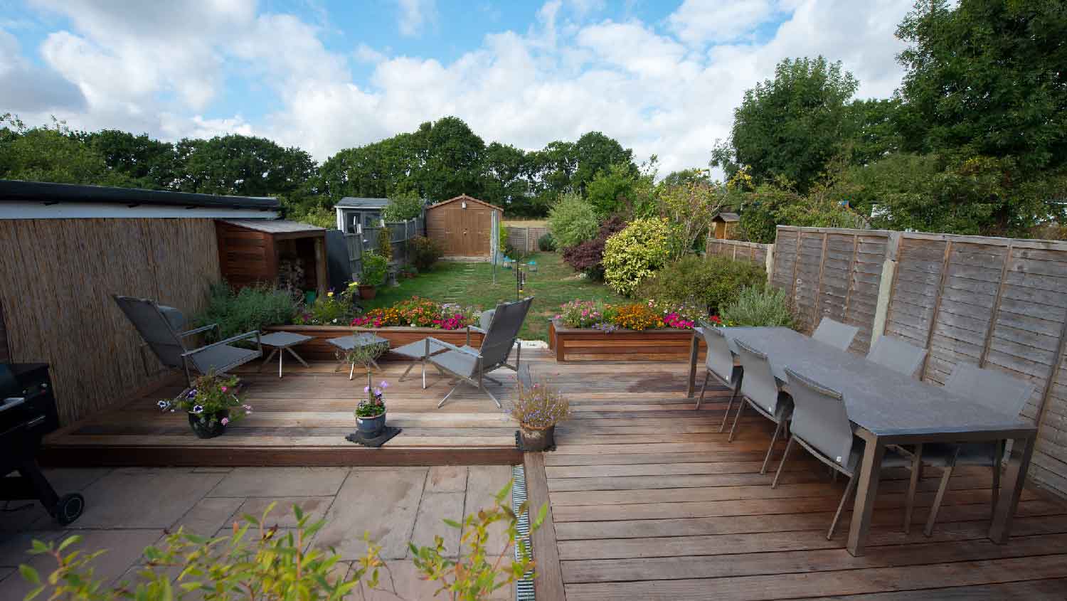 A wooden deck overlooking the backyard