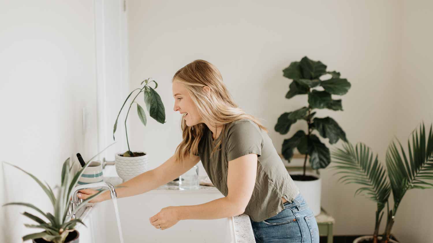 Woman washing hands in sink