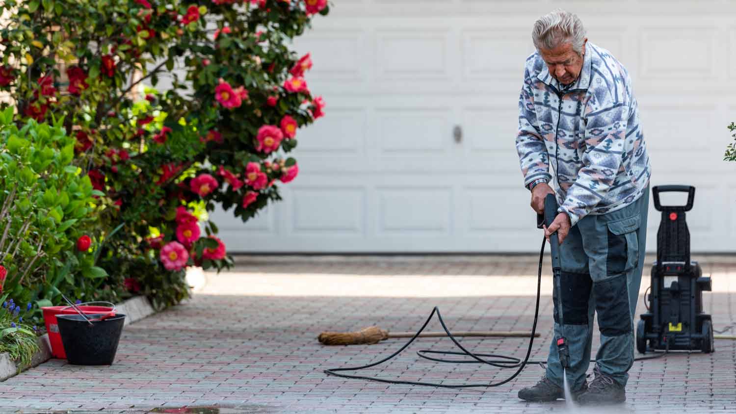 older man cleaning the yard