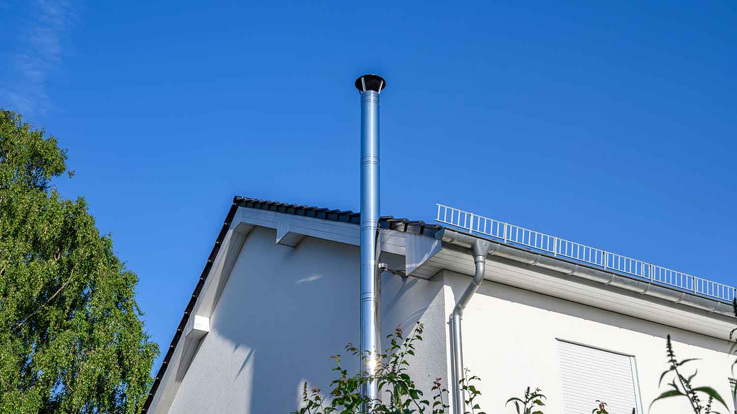 Stainless steel chimney flue installed outside of the house