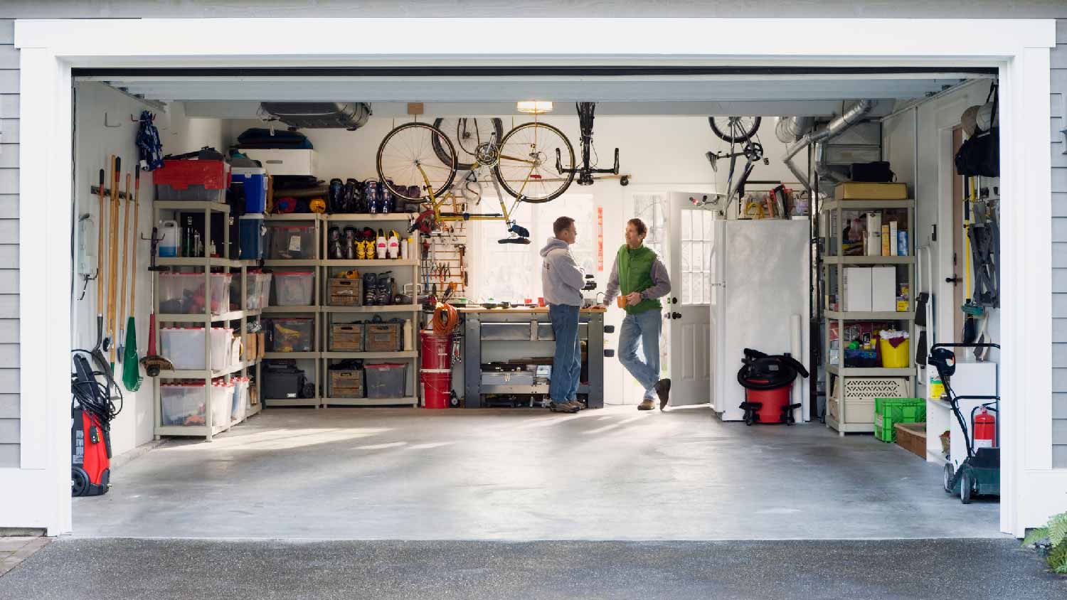 Two men talking in a home’s garage