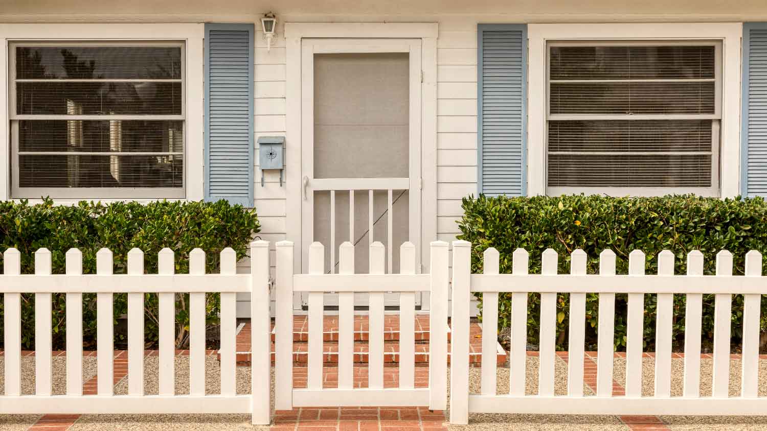 The entrance of a house with a screen storm door