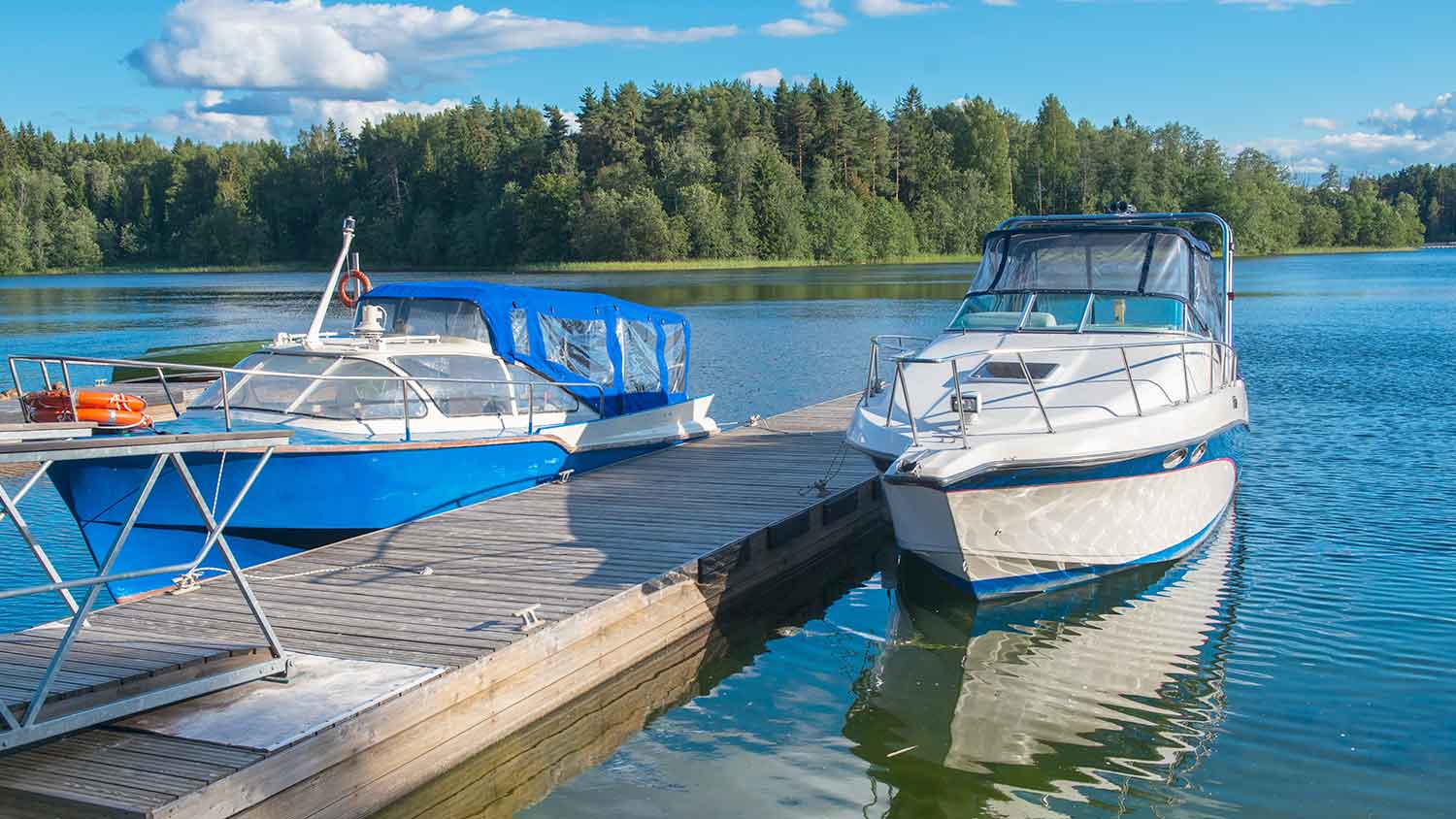 Two boats tied to a wooden dock