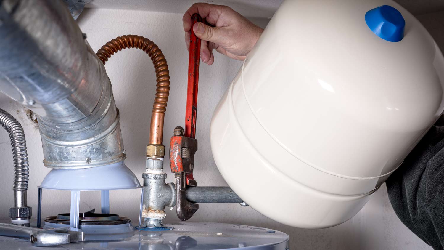 plumber does maintenance on hot water heater