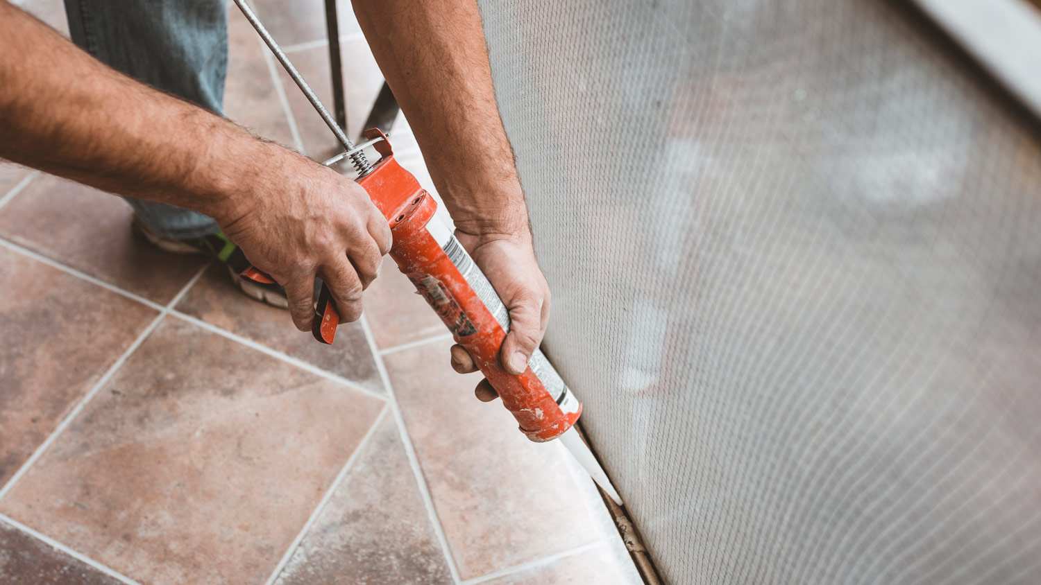 Construction Worker Using Silicone Glue