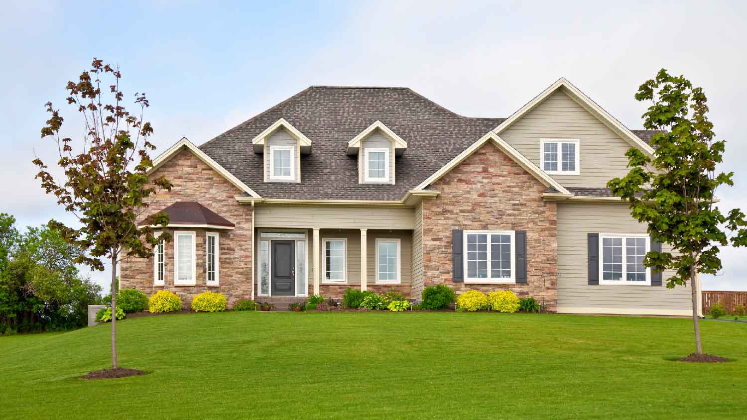The exterior of a suburban house with a large yard