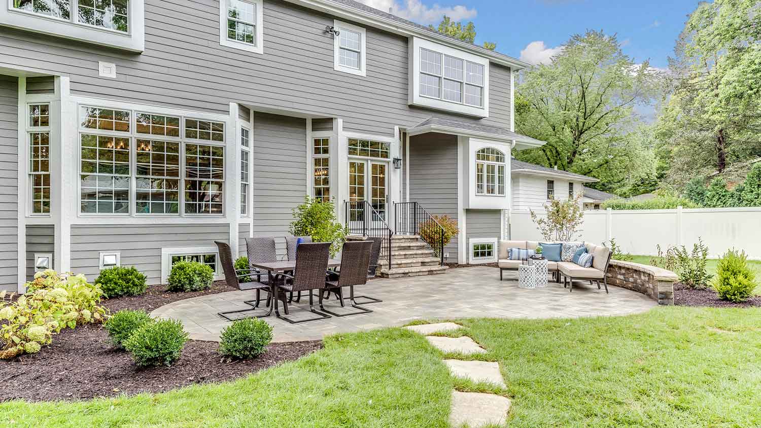 Large stone patio in the backyard of the house