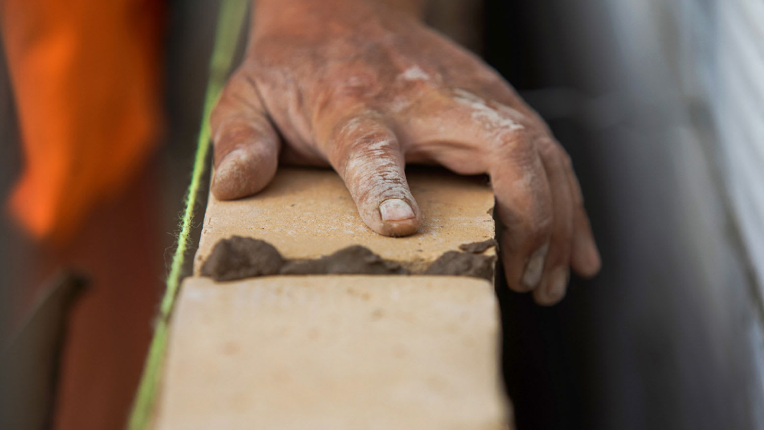 Close-up of a person laying brick and mortar