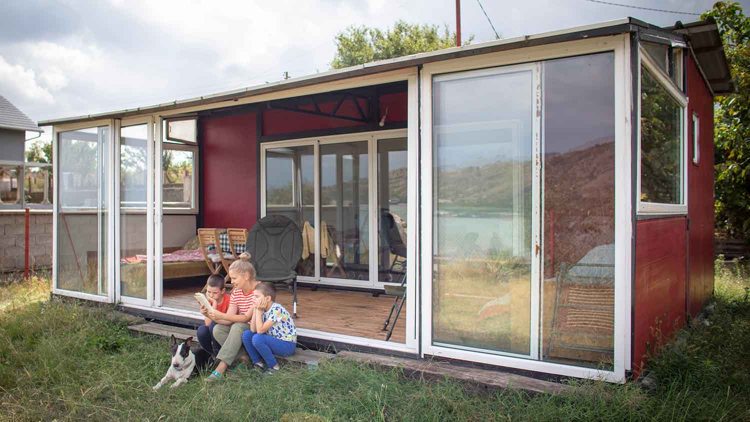 Mother and children sitting outside of a guest house
