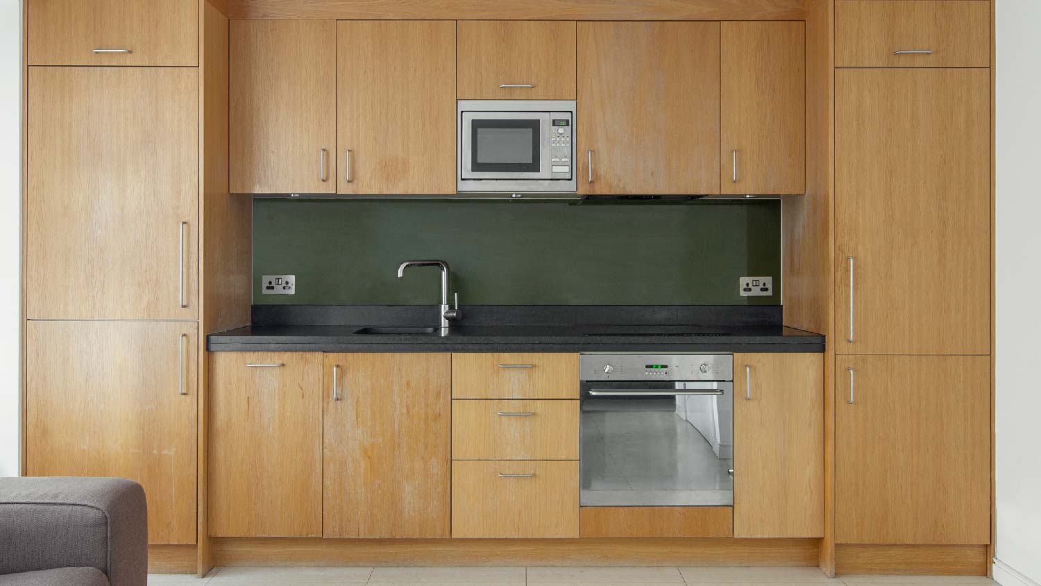 A kitchen with wooden cabinets