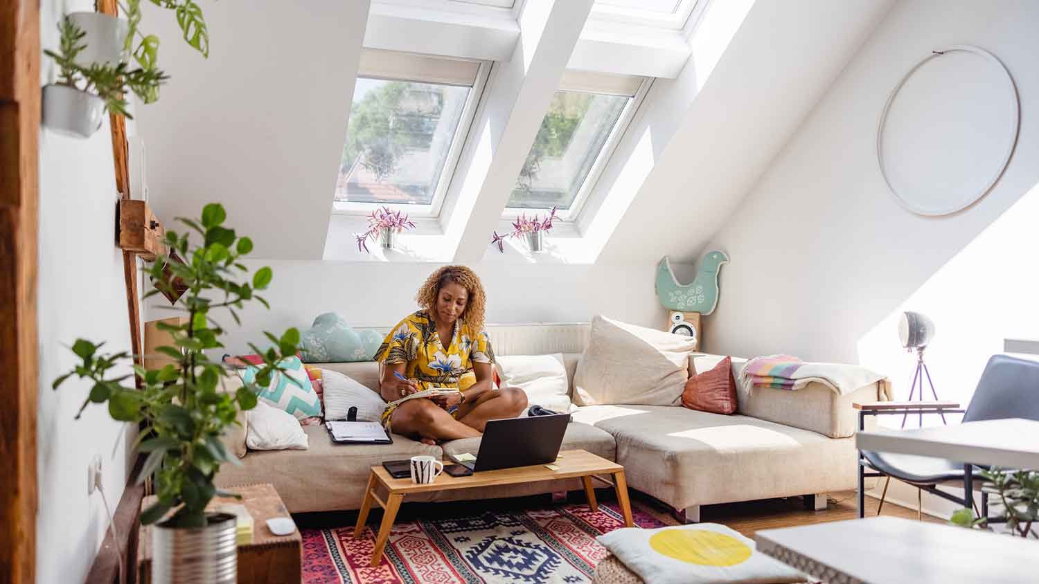 Woman sitting on a couch and taking notes