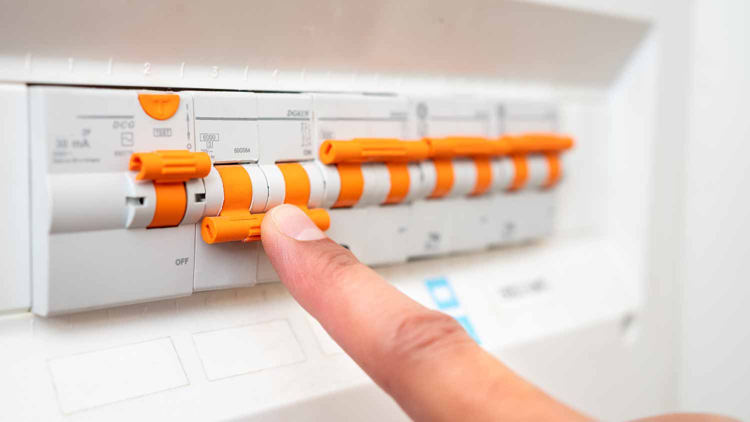 Man turning off the fuse box
