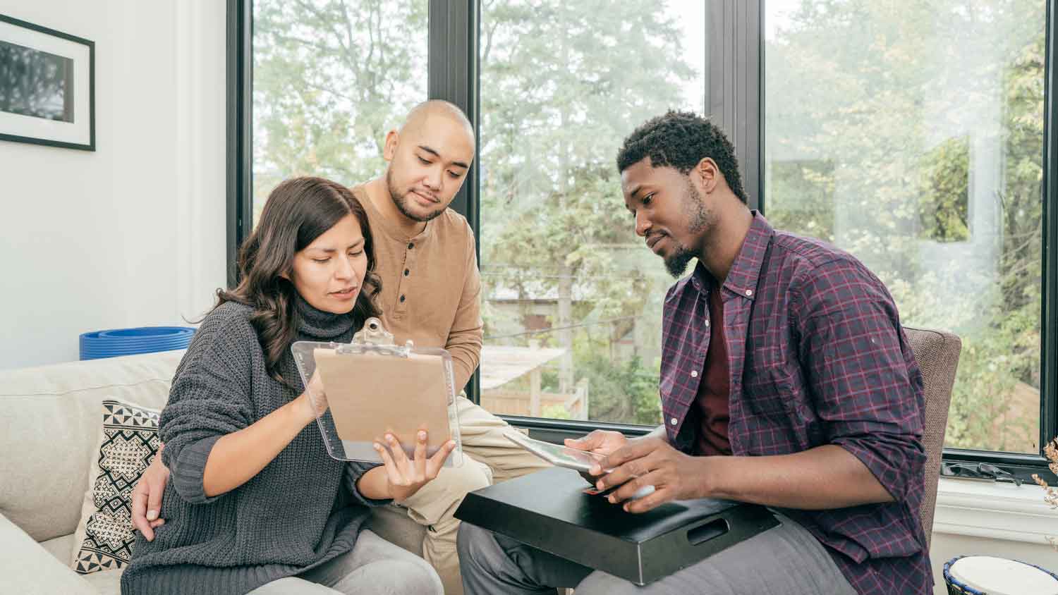 Clients and contractor reviewing project contract